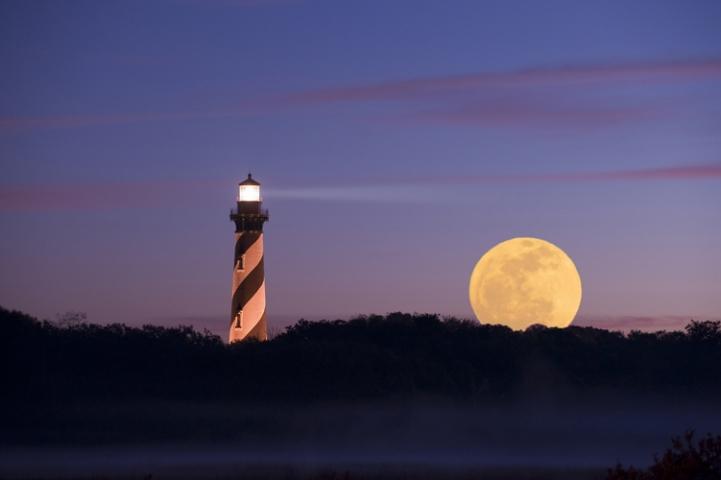 lighthouse against the moon